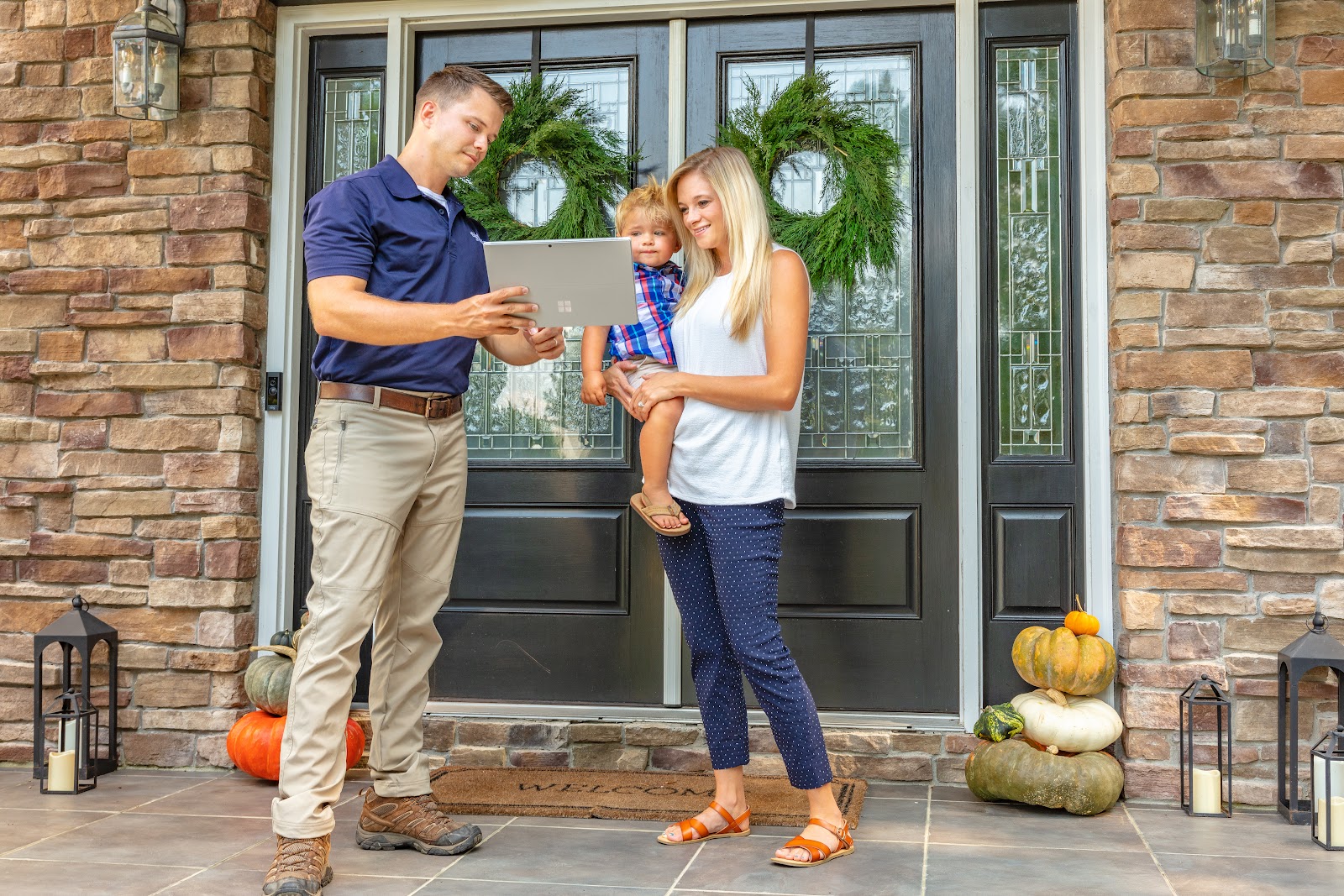 Eastline Pest Management technician consulting with a family at their home