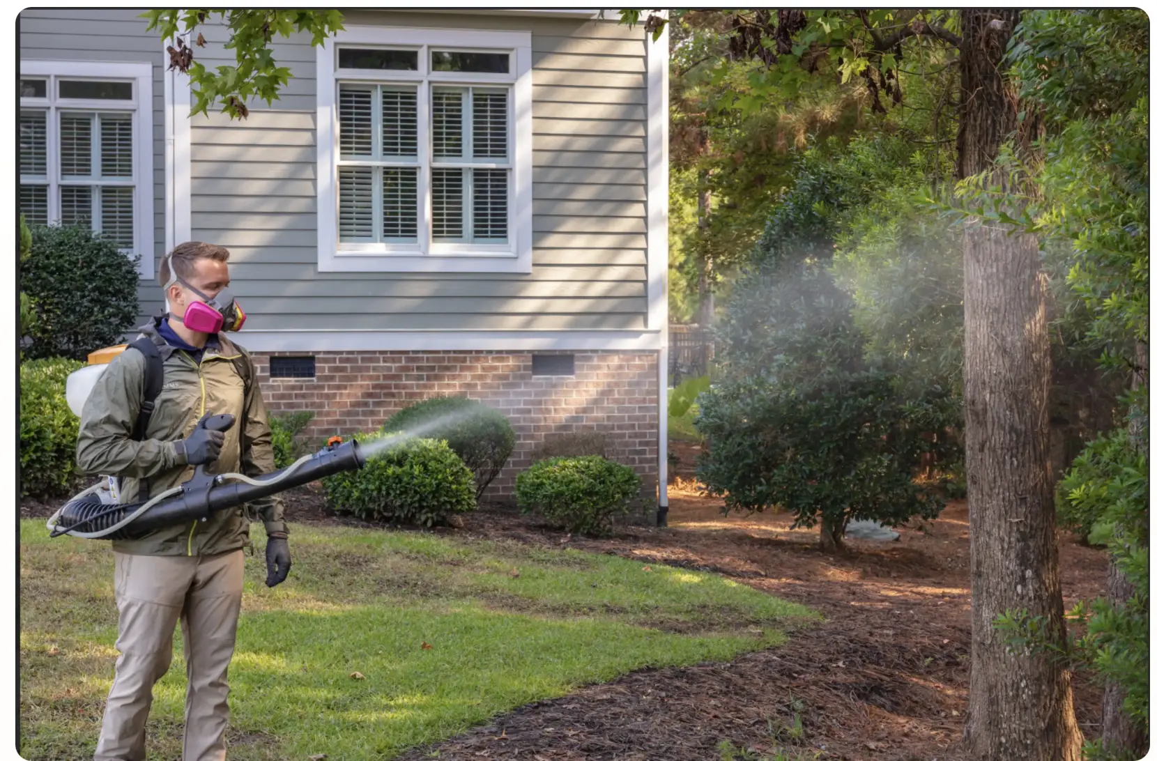 Eastline Pest Management technician treating a yard near New Bern, NC